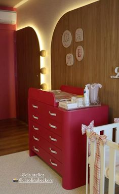 a baby's room with a dresser and crib