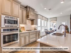 a large kitchen with an island and stainless steel appliances