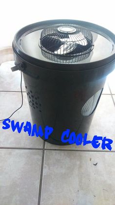 a black trash can sitting on top of a tile floor with the words swamp cooler written below it