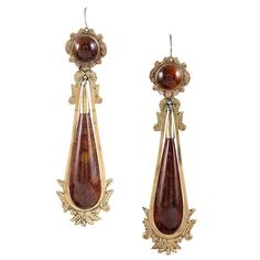 Ornate borders of 14k yellow gold frame smooth drops of polished brown agate. Fitted with vintage style ear wires that insert from the back of your ear lobe, which can be converted to modern ear wires on request. 3 inches long. Classic Brown Jewelry With Matching Earrings, Brown Teardrop Earrings For Formal Occasions, Formal Brown Jewelry With Polished Finish, Brown Dangle Jewelry For Formal Occasions, Formal Brown Teardrop Earrings, Vintage Brown Jewelry With Polished Finish, Elegant Brown Brass Jewelry, Elegant Brown Brass Earrings, Elegant Oval Brown Earrings