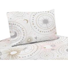 a white and gold bed set with stars, moon and sun designs on it's sheets