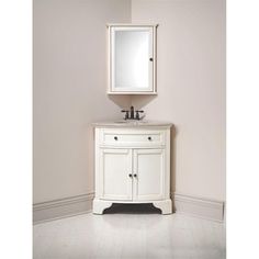 a white bathroom vanity with a mirror above it