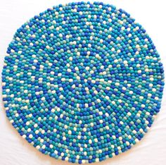 a blue and white plate sitting on top of a table next to a white wall