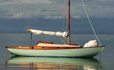 a small sail boat floating on top of the water