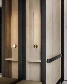 the interior of a hotel room with marble walls and black trimmings, including a bench