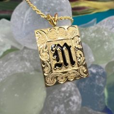 Feel the aloha with this personalized pendant! Our custom-engraved Hawaiian Scroll Heirloom Initial Pendant is available in 14k gold plated sterling silver or sterling silver. Add a special message to the back for just $15 and guarantee it's one-of-a-kind! Each pendant comes with a 20" gold-filled rope chain, making it perfect for both men and women. Mahalo! 14K Gold Plating over .925 Sterling Silver or Sterling Silver Choose Initial in Black Enamel or Raised Lettering Pendant is approx. 1" Tall Vintage Jewelry Initial Pendant For Personalized Gift, Personalized Yellow Gold Square Pendant Jewelry, Engraved Custom Nameplate Necklace For Anniversary, Engraved Nameplate Jewelry For Anniversary, Heirloom 14k Gold Personalized Necklaces, Personalized Heirloom 14k Gold Necklaces, Vintage Personalized Pendant Jewelry Gift, Heirloom 14k Gold Personalized Necklace, 14k Gold Rectangular Pendant Jewelry For Personalized Gift