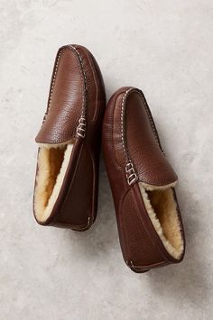 Sleek, sophisticated, and built for plush comfort, the Colt leather moccasins offer timeless style for luxurious lounging. These handsome slippers are crafted from embossed full-grain leather, with 100% genuine Australian Merino sheepskin lining for insulation, breathability, and cloudlike softness. Hand whipstitching along the vamp and heel offer a distinguished finish. Includes a two-layer EVA foam midsole and wedge heel for comfort and durability. Etsy Clothing, Moccasin Slippers, Shearling Slippers, Sheepskin Slippers, Wool Coats, Moccasins Slippers, Leather Moccasins, The Vamp, Leather Slippers