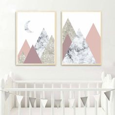 two paintings on the wall above a crib in a baby's nursery room