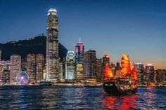 an image of a boat in the water with city lights on it's side