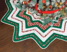 a crocheted christmas tree skirt is on the floor