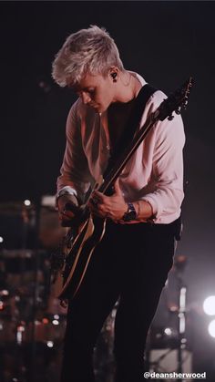 a man playing an electric guitar on stage