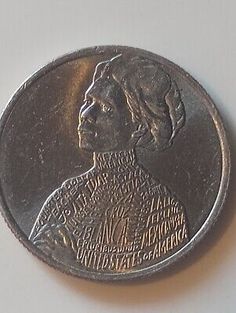 a coin with the image of a woman on it's face and words written in different languages