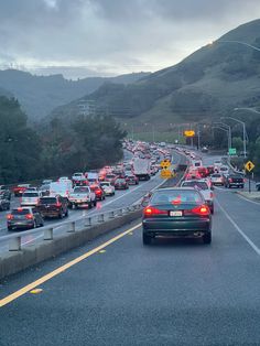 many cars are driving down the highway in heavy traffic