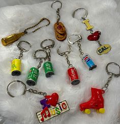 several key chains with various items on them sitting on a white furnishing surface