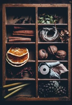 an old wooden box filled with different types of food and spices, including oranges