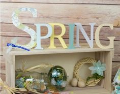 a wooden shelf with spring decorations on it