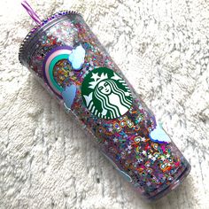 the starbucks cup is decorated with glitter and stars