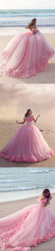 a woman in a pink dress on the beach