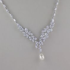 "'Meghan' White Gold Crystal Bridal Necklace has been created in a sparkling 'Y' design using marquise shaped cubic zircon crystals. Crystals set in a rhodium base extend around the neck creating an extremely flattering necklace. A Swarovski teardrop pearl creates a pretty pendant drop. We used ivory white in the photos. Measures: L = 16.5\" (40.5 cm) with an optional 1.5\" extender. 💛This listing is for the necklace only. Highest quality cubic zircons set in tarnish resistant 18K rhodium(aka w Wedding Diamond Necklace With Marquise Cut Accents, Cubic Zirconia Diamond Necklace For Wedding, Marquise Cut, Wedding Diamond Necklace With Marquise Cut And Diamond Accents, Cubic Zirconia Marquise Cut Wedding Necklace, White Marquise Cut Diamond Necklace For Wedding, Marquise Cut Diamond Necklace With Accents For Wedding, White Marquise Cut Diamond Wedding Necklace, Marquise Diamond Necklace For Wedding, Marquise Cut Diamond Necklaces For Weddings