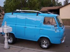 a blue van is parked on the side of the road near a fire hydrant