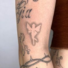 a woman's arm with tattoos on it and the word fila written in cursive writing