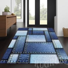 a blue area rug with patchwork denims on the floor in front of a door