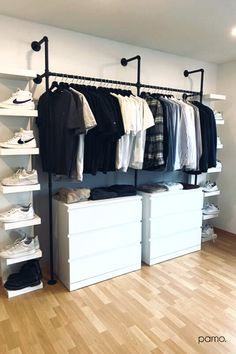 an organized closet with white drawers and clothes hanging on the rails, along with shoes