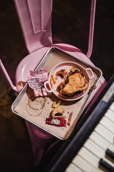 a tray with food on it next to a piano