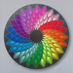 a multicolored circular design on the wall