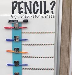 a bulletin board with pencils attached to it