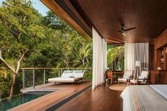 a bed sitting on top of a wooden floor next to a lush green forest