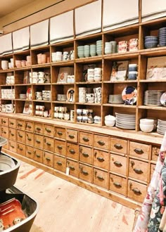 the shelves are full of dishes and bowls