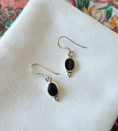 These elegant black dangle earrings are crafted of sterling silver and are lightweight for all day wear. - Simulated Black Onyx Inlay - Crafted of genuine sterling silver - 1/2" High (without hooks) and 1/4" Wide - Weight is about 2.1 grams Orders will ship out in 1-3 business days from my Arkansas studio. In addition to your jewelry, you'll receive a silver polishing cloth and art extra such as bookmark or mini print. Jewelry will be wrapped in anti-tarnish paper and placed inside a white box o Nickel-free Black Earrings For Gift, Black Hypoallergenic Sterling Silver Jewelry, Classic Black Drop Earrings, Minimalist Black Sterling Silver Earrings, Black Drop Earrings For Everyday, Black Hypoallergenic Sterling Silver Earrings, Black Hypoallergenic Dangle Earrings, Everyday Black Drop Earrings, Everyday Black Sterling Silver Earrings