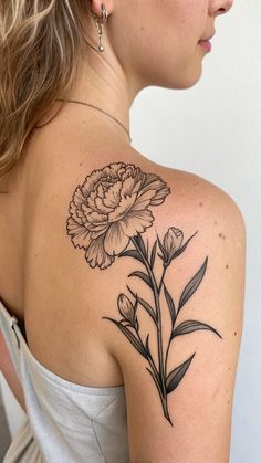 a woman with a flower tattoo on her shoulder