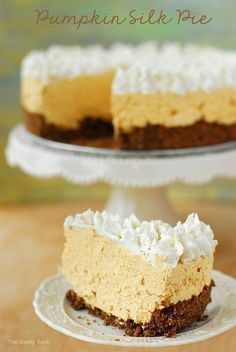 a slice of pumpkin silk pie on a plate with the rest of the pie in the background