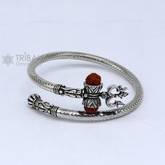 Vintage antique design handmade 925 sterling silver amazing rudraksha beads bahubali shiva trident trishool kada bangle bracelet, excellent gifting jewelry from Rajasthan india. Metal-925 Sterling silver. Item type-Bangle/Bracelet/kada Weight-35.570 grams approx. Width-5.mm bangle size size-adjustable by twisting it.(inner diameter-6.0 cm)2-6(we can easily wear bigger size like 2-8) Stamped-925. finish-Oxidized. Excellent gifting jewelry Adjustable Silver Jewelry For Puja, Spiritual Bangle For Puja, Spiritual Sterling Silver Jewelry For Navratri, Symbolic Silver Jewelry For Puja, Silver Spiritual Jewelry For Navratri, Symbolic Jewelry For Navratri Puja, Symbolic Bracelet Jewelry For Puja, Symbolic Jewelry For Puja And Navratri, Adjustable Spiritual Jewelry For Navratri