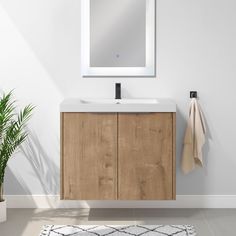 a bathroom vanity with a mirror above it and a rug on the floor next to it