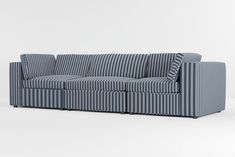 a blue and white striped couch sitting on top of a white floor