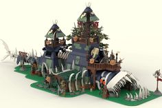 a lego model of a castle with lots of animals and people on top of it