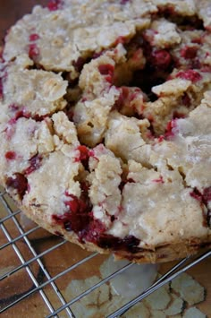 a close up of a doughnut on a cooling rack with crumbs around it