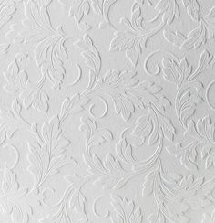 white wallpaper with an intricate design on it's surface and the background is painted in