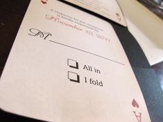 two envelopes sitting on top of a table with playing cards in front of them