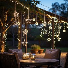 a table with some lights hanging from it's sides and stars on the ceiling