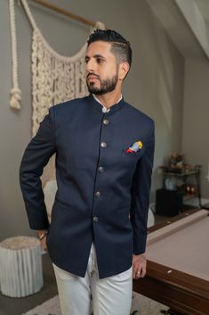 Distinguish yourself in this premium quality, forever-classic, navy blue Bandhghala jacket Note: Pocket square not included Product Midnight blue light wool shell, burgundy paisley satin lining. The fabric is light and comfortable for all year 'round wear! Model's height is 6'0" (170 lbs) and is wearing a size Medium Detailed sizing chart here How to wear Versatile jacket to rock at a formal reception, wedding ceremony or Sangeet night Style with a crisp Ivory shirt and Ivory or Cream pants or n Formal Wedding Reception, Sangeet Night, Pocket Square Pattern, Plain Jacket, 170 Lbs, Reception Ceremony, Cream Pants, Versatile Jacket, Navy Blue Pants