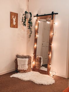 a room with a mirror, rug and lights on the wall next to a bed