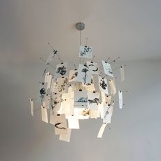 a chandelier with pictures hanging from it's sides and the words theme ink and wash