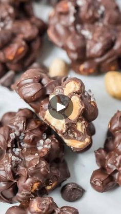 chocolate covered pretzels and cashews on a white surface with a video playing in the middle