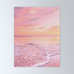 a greeting card featuring birds flying over the ocean at sunset with pink and yellow colors