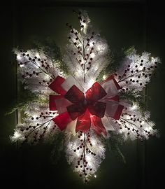 a christmas wreath with lights and decorations on it