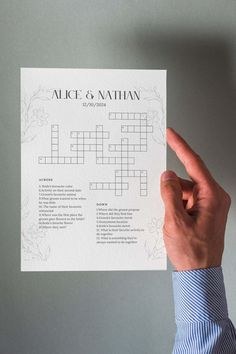 a person holding up a crossword puzzle piece